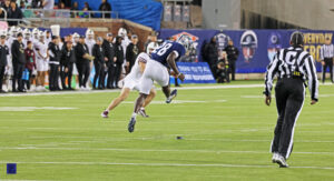 Rice kickoff specialist Enock Gota in the middle of his kicking motion