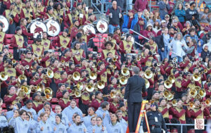 The band director at Texas State gets the band going during the game